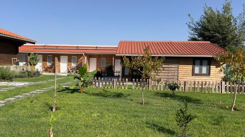una casa con una valla delante de un patio en Chalé do Vale en Pinhal Novo