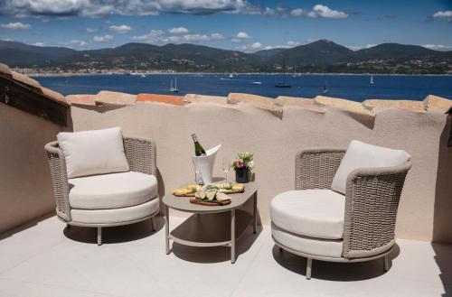 two chairs and a table on a balcony at Tinah Saint-Tropez in Saint-Tropez