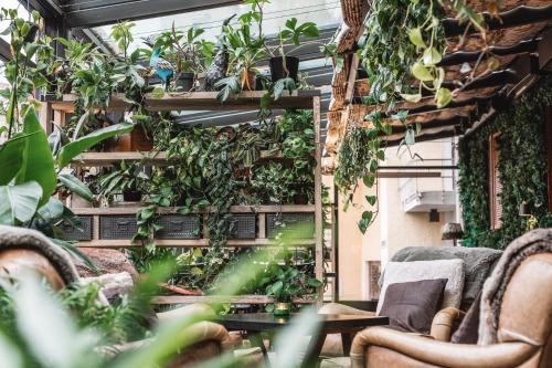 a patio with plants and chairs in a building at Arctic Light Hotel in Rovaniemi