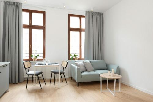 a living room with a couch and a table at The Bank Poznan Apartments in Poznań