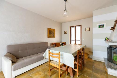 a living room with a couch and a table at Villetta Macchia Mediterranea in Cuglieri