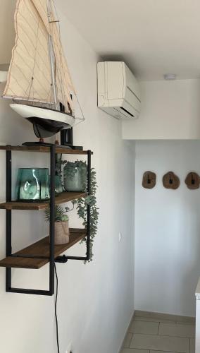 a shelf with a model boat on a wall at Maison du pêcheur bord de mer - 2 à 4 pers in Saint-Raphaël