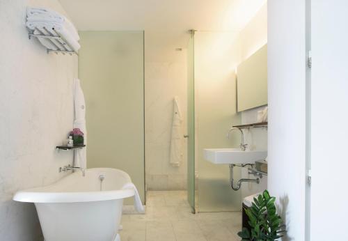 a bathroom with a toilet and a sink at Hospes Maricel y Spa, Palma de Mallorca, a Member of Design Hotels in Cas Catala