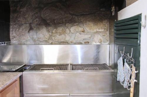 a kitchen with a stainless steel stove top oven at Casa na Aldeia in Arcos de Valdevez
