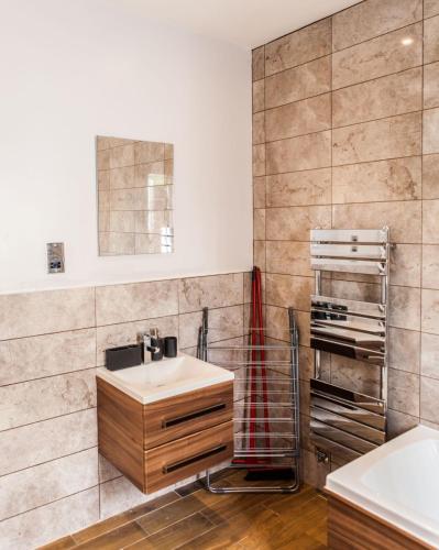 a bathroom with a sink and a shower at Cyrus House in Dartford