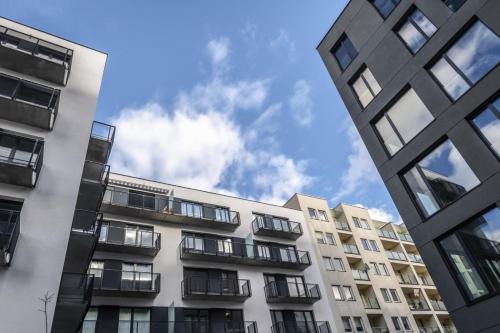 a tall apartment building with the sky in the background at Małe Garbary 8 Apartment in Poznań