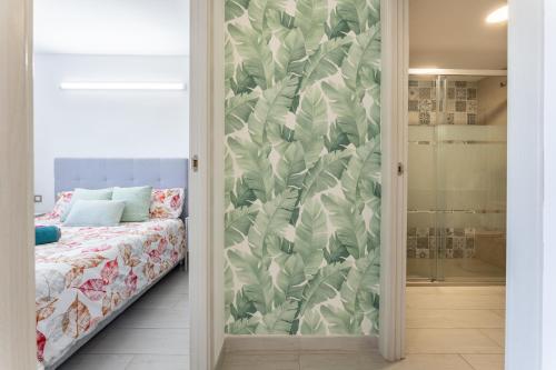 a sliding glass door leading to a bedroom with a bed at Arquus Little Hawaii in Salou