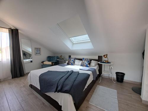 a bedroom with a large bed with a skylight at Adriatic Pearl Korcula in Korčula