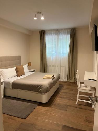 a bedroom with a bed and a desk and a chair at The Garden Madrid in Madrid