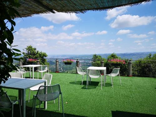 a group of tables and chairs on the grass at Rocche Costamagna Art Suites in La Morra