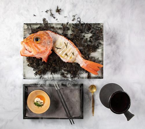 a fish on a plate next to a bowl of food at Hotel Pepe Vieira in Raxo