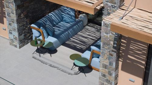 an overhead view of a blue couch on a patio at Cayo Exclusive Resort & Spa in Elounda
