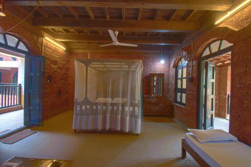 a room with a bed and a curtain in it at Konkan Nest Resort in Ganpatipule