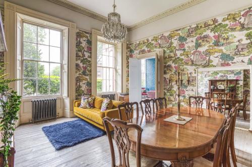 a dining room with a table and a couch at Friar Gate House - Grand Georgian Townhouse in Derby Centre in Derby