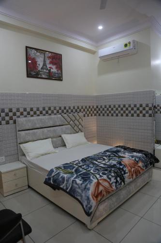 a bedroom with a large bed with at Luxury Room with 1 Double Bed in Haridwār