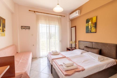 a bedroom with a large bed and a couch at Iliadis House in Sarti