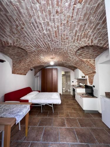 a room with a bed and a brick wall at Ca' D'Rosina in Narzole
