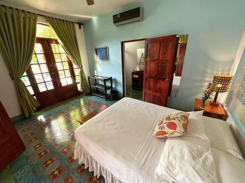 a bedroom with a white bed with a pillow on it at Hotel La Polvora in Granada