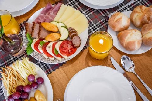 a table topped with plates of food and bread at Cicha Woda 300 m od Gorący Potok i Termy Szaflary in Szaflary
