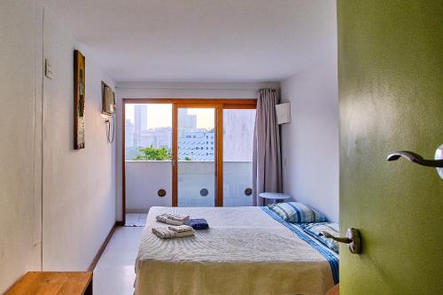 Habitación pequeña con cama y ventana en Casa da Gente, en Río de Janeiro