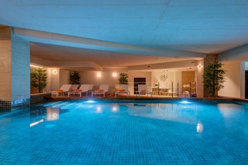 a large swimming pool in a hotel at Noru Hotel Malta - Adults Only Hotel in St Julian's