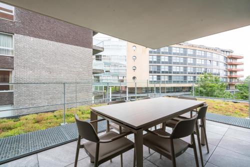a table and chairs on the balcony of a building at Paradisio II in Oostduinkerke