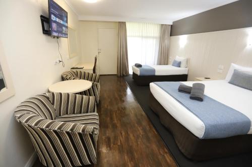 Ένα ή περισσότερα κρεβάτια σε δωμάτιο στο Sleepy Hill Motor Inn