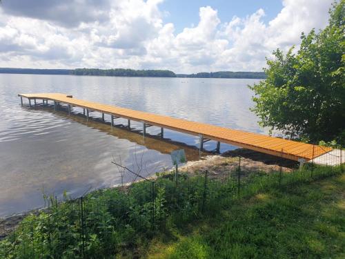 a dock in the middle of a lake at Junior-Suite Relaxe am See in Ascheberg