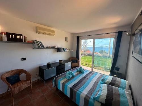 une chambre avec un lit et une grande fenêtre dans l'établissement Maison provençale avec vue sur mer, à Marseille