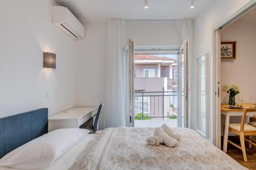 a bedroom with a bed and a desk and a window at Centrally located apartments, free parking in Trogir