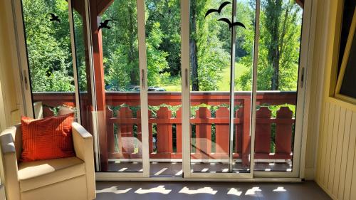 a room with a balcony with a large window at Villa Blu in Sankt Kanzian