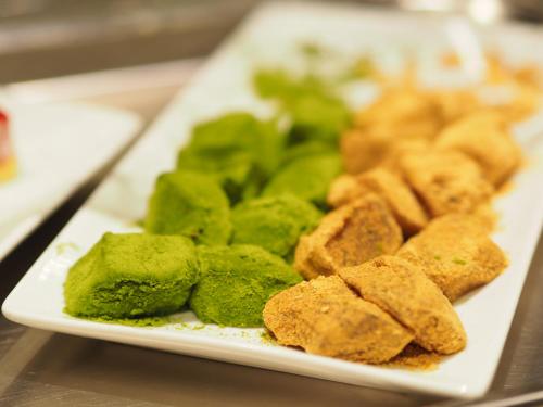a plate of food with broccoli and other foods at Dormy Inn Premium Osaka Kitahama in Osaka