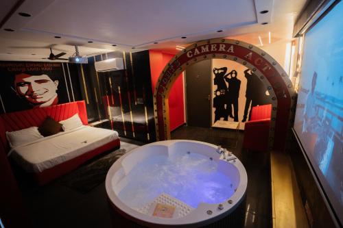 a room with a bed and a tub in it at Orsom Stays Sassy - Sector 42 in Gurgaon
