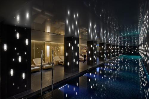 a pool in a hotel with lights on the wall at Mandarin Oriental Mayfair, London in London