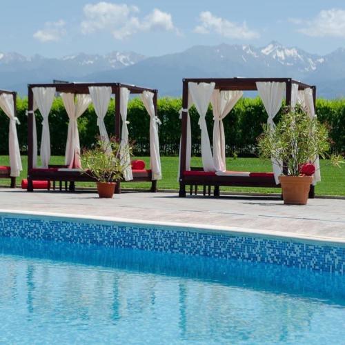 a row of benches next to a swimming pool at Aqua Club Elatis in Avrig