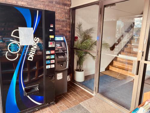 a video game vending machine next to a building at Travelodge by Wyndham Valleyfair Shakopee in Shakopee