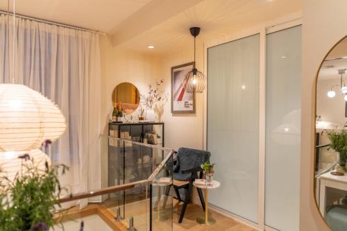 a room with a glass staircase and a chair at Loft on Collins/Swanston - 2 storey - 2 bed 2 bath in Melbourne