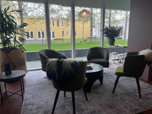 a room with chairs and tables and a large window at Hótel Bifröst in Bifrost