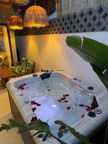 a jacuzzi tub in a room with a plant at City Compass Luxury Suites Faliraki in Faliraki
