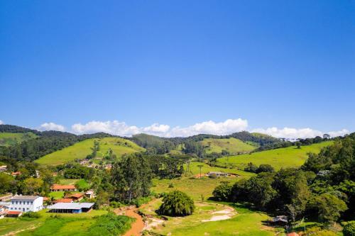a view of a village in the hills at VELINN Pousada Cesar in Santo Antônio do Pinhal