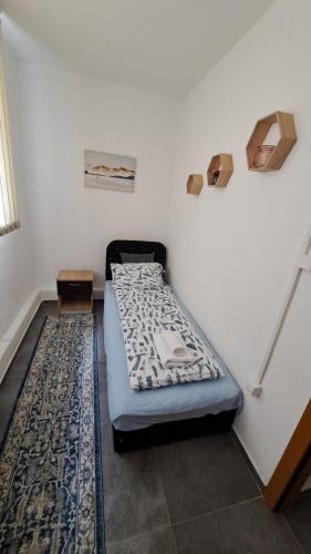 a bed sitting in a corner of a room at Elita Prenoćište in Bihać
