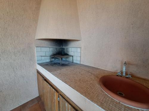 a bathroom with a sink and a fireplace at villetta costa paradiso in Costa Paradiso
