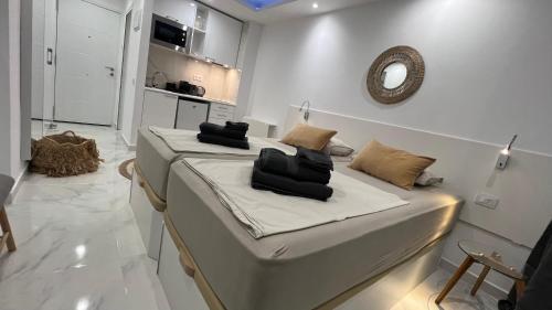 a room with a bed with a mirror on the wall at Tenerife Sea View Sun Beach Apartment 220 in Playa Fañabe