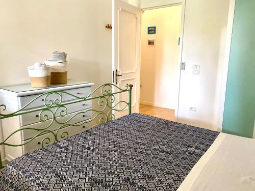 a bedroom with a bed with a black and white comforter at Eleutheria beach villa by the beach in Torre Chianca