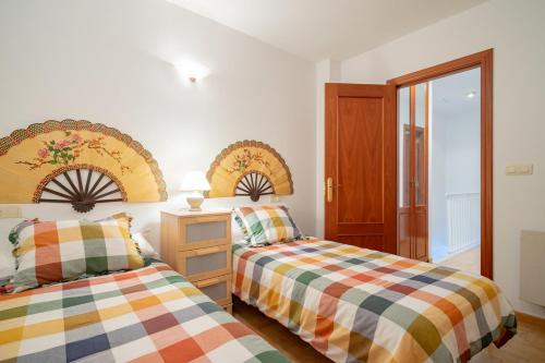a bedroom with two beds and a window at Appto Scott en Ribadesella VUT5829AS in Ribadesella