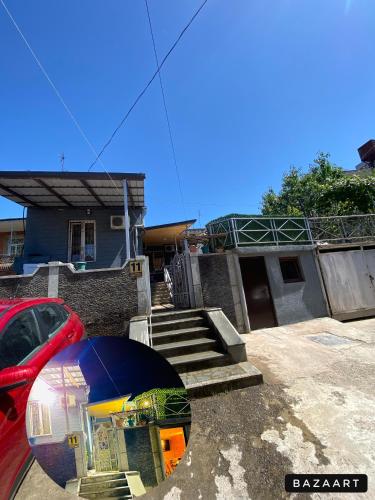 a house with a car parked in front of it at Anna'S Home in Kutaisi