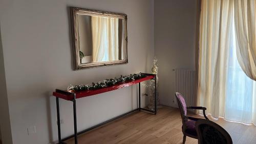 a room with a mirror and a table and a chair at Rosarias Rooms in Manfredonia