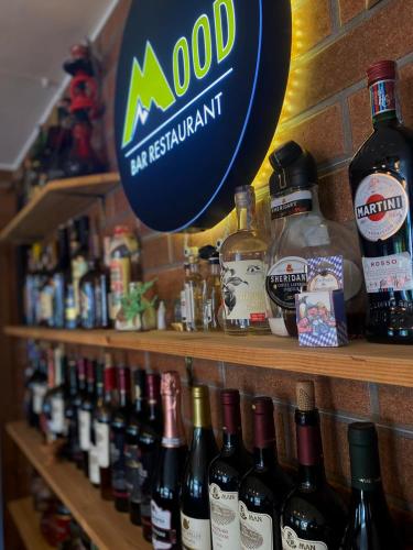 a store shelf filled with lots of bottles of wine at Mood Hotel Kazbegi in Stepantsminda