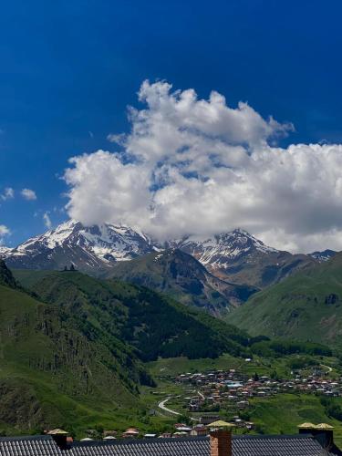 a view of a mountain range with snow covered mountains at Mood Hotel Kazbegi in Stepantsminda