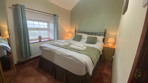 a bedroom with a bed with two towels on it at Sunnyside hottub Brecon Beacons sleeps 8 in Lower Chapel